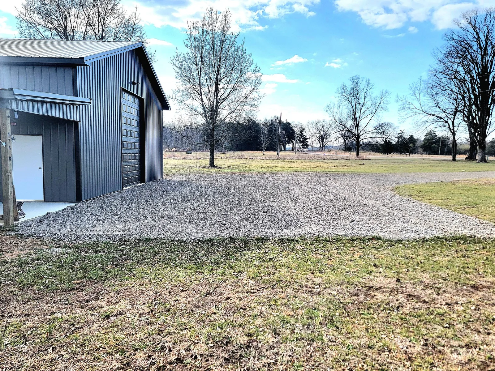 Crusher run driveway and pad in front of a barn