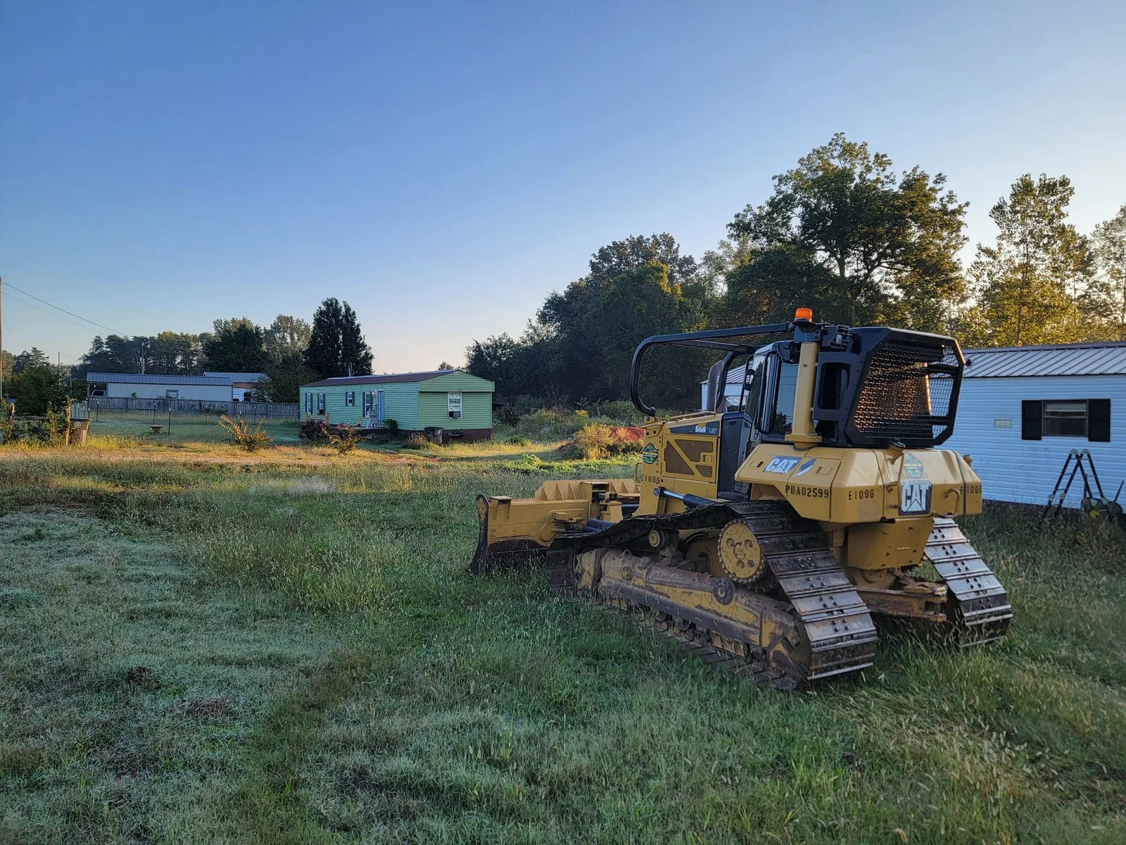 Dozer on a pasture before stripping topsoil and pushing up a pad