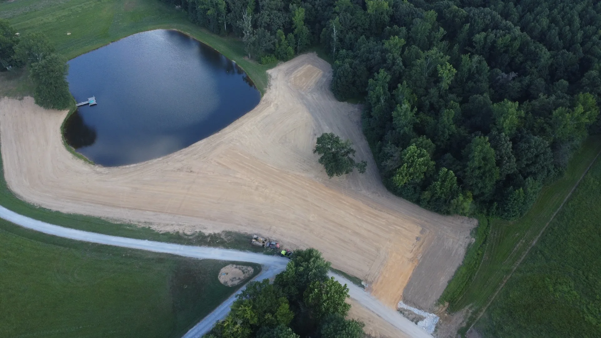 Drone view of a graded pad and pond after moving about nine thousand yards of earth