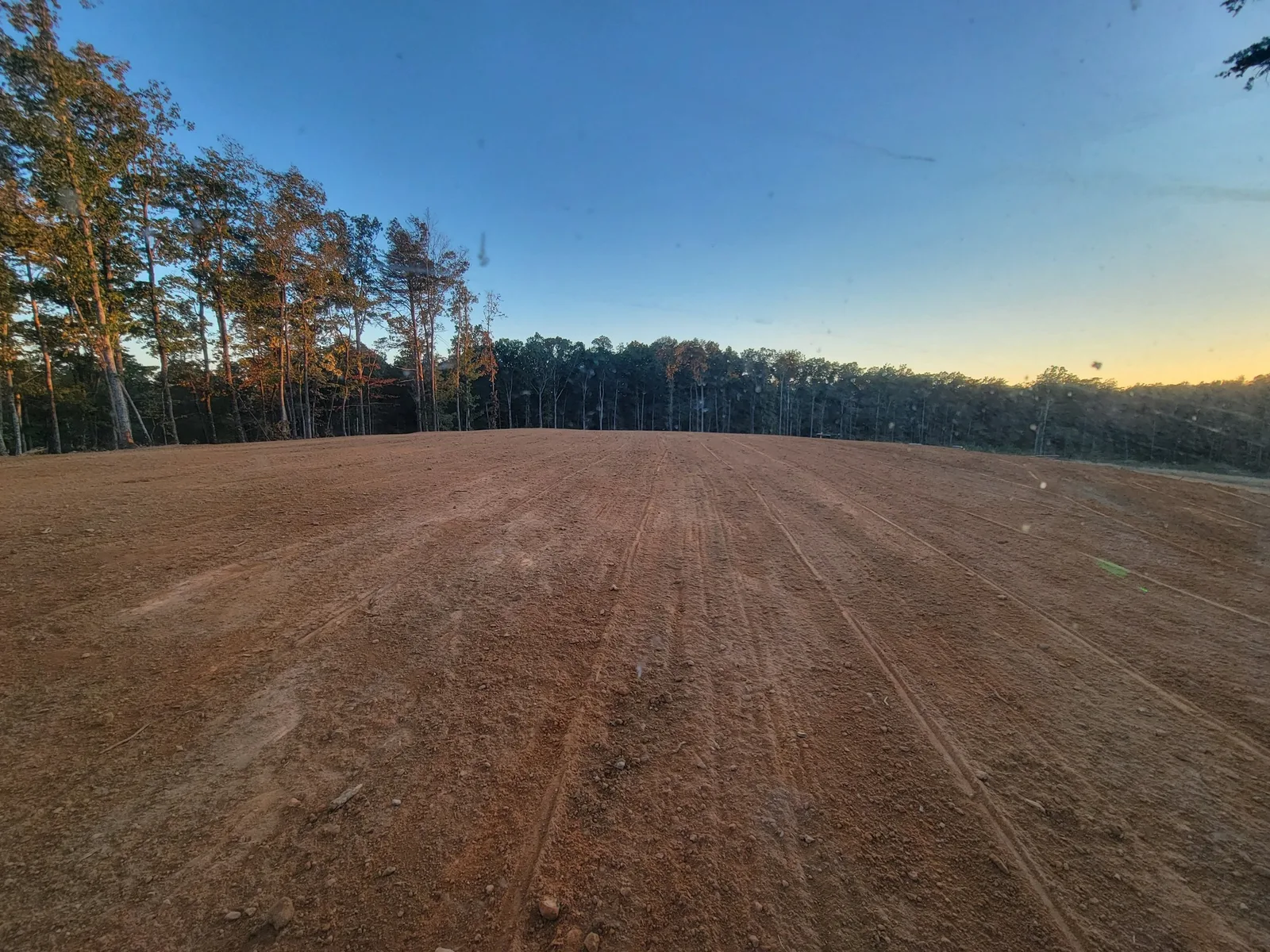 Graded building pad at the end of the day, slicked up for rock
