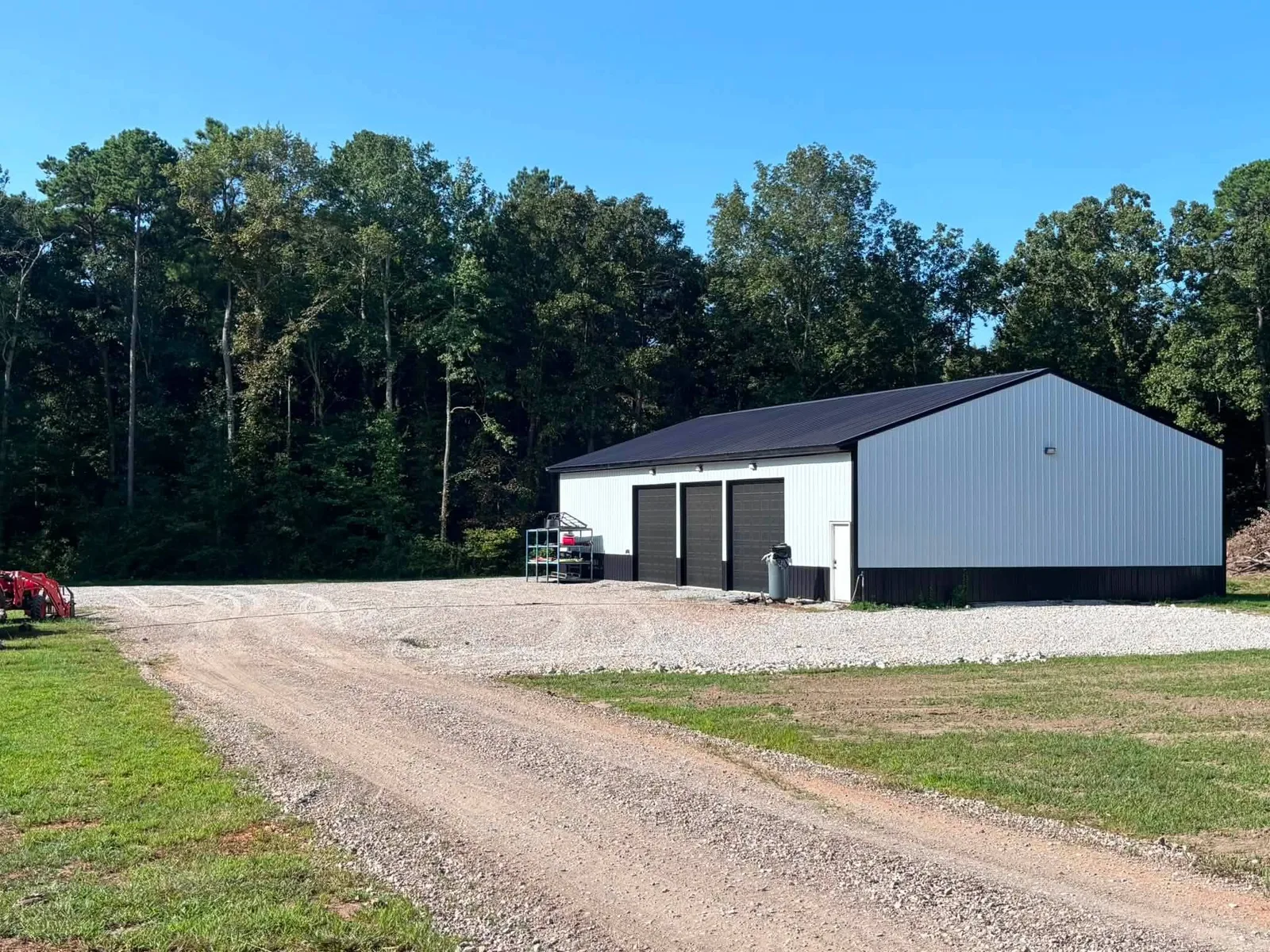 Gravel drive and parking area graded beside a shop building