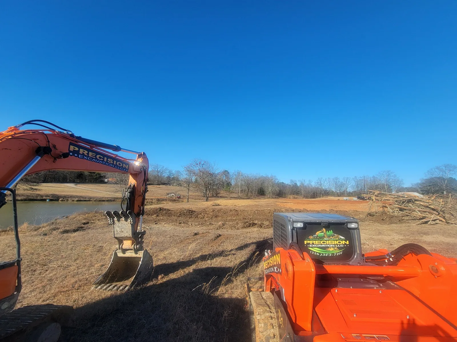 Mulching head on the skid steer with the ground mulched behind it