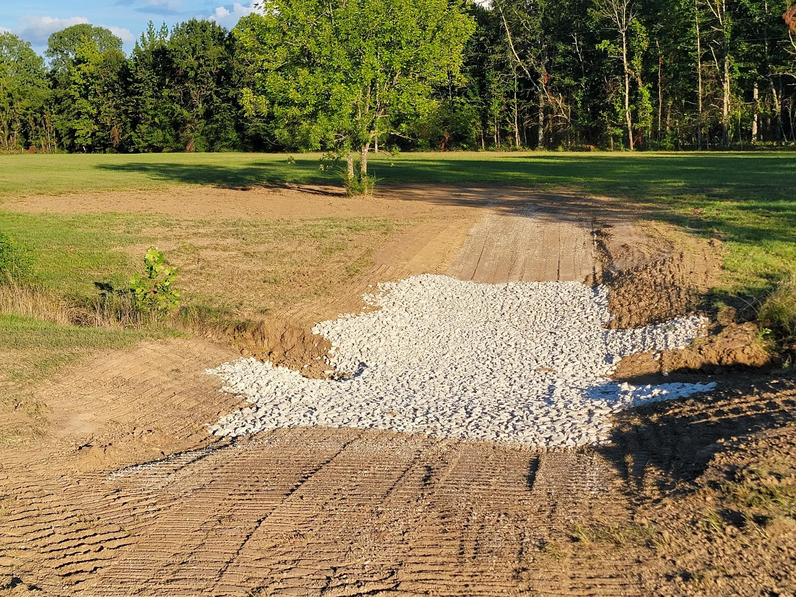 Rock spread and shaped on a driveway base