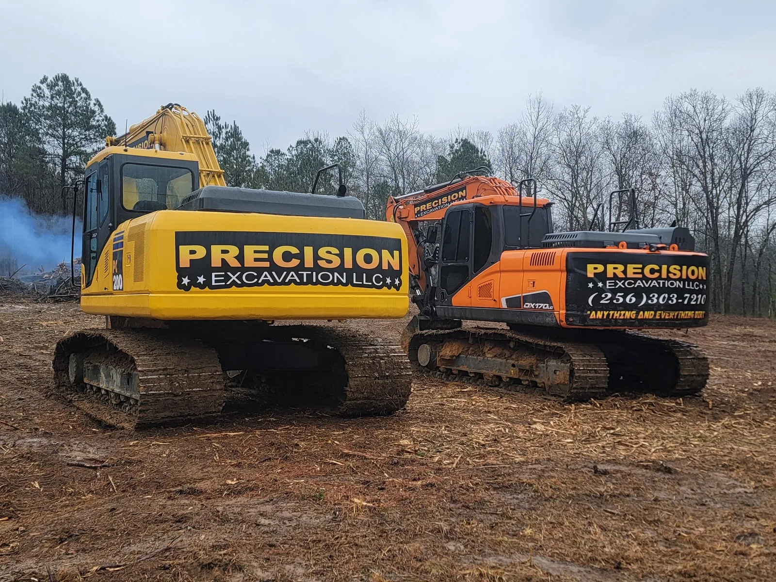 Precision Excavation LLC lettering on the side of a trackhoe