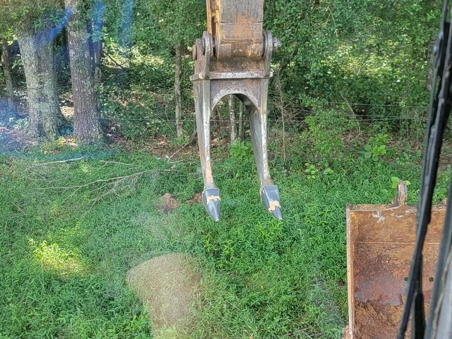 Trackhoe pulling stumps on a five acre clearing